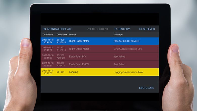 A tablet shows an industrial error message display with warning and error logs.
